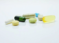 Pharmaceutical industry icon with pill and cross symbol